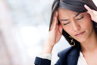 Portrait of stressed business woman with a headache.jpeg